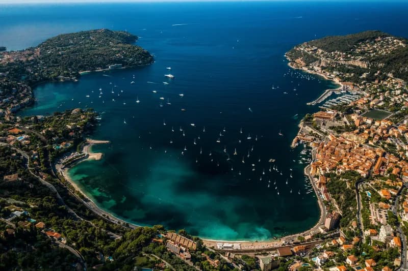 Aerial view of a Riviera bay full of anchored yachts